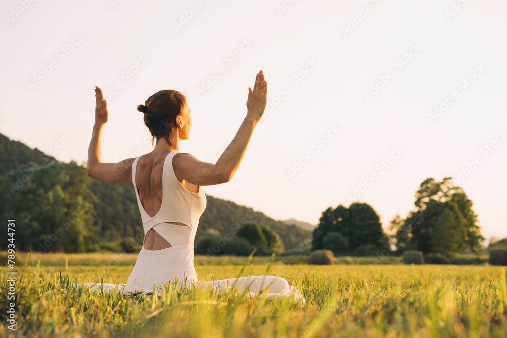 Young woman practicing yoga on nature. Young woman practicing yoga on nature.