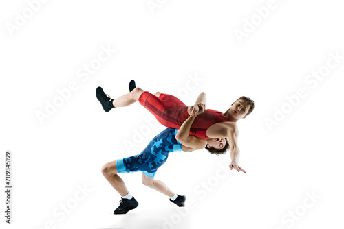 Young boys, athletes wrestling, training, displaying skill and strategy for victory, isolated on white background. Concept of combat sport, martial arts, competition, tournament, athleticism © master1305