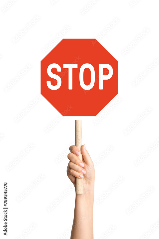Hand holding stop sign on blank background