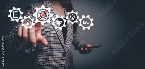 Businesswoman with assessment for certificate good quality product on virtual screen. Standard check quality control, quality assurance management, QC and QA iso, service guarantee, validation concept
