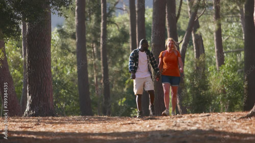 Loving couple holding hands on hike in countryside together- shot in slow motion Loving couple holding hands on hike in countryside together- shot in slow motion