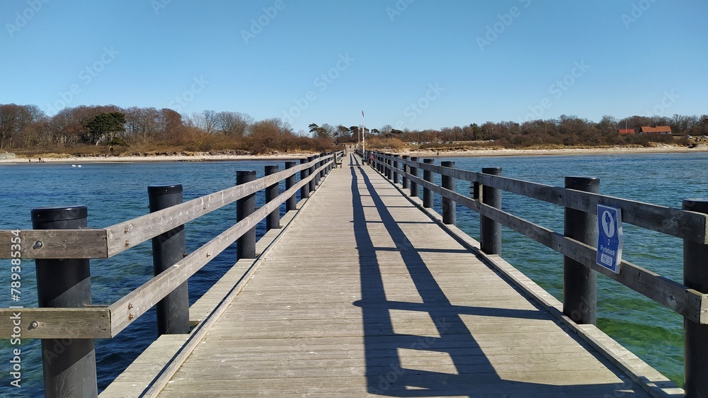 Wooden pier in the sea on the beach near the shore