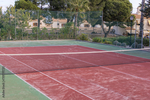 Empty public professional tennis court. Vacation in low season. Resort spot without people. Alicante, Spain