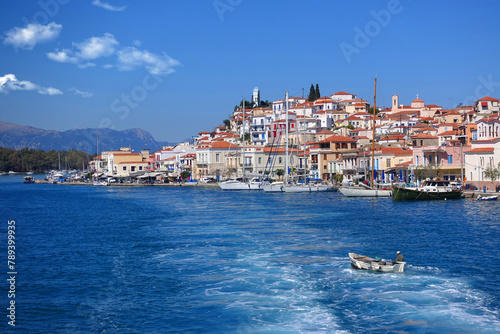 Famous main picturesque village of Poros island featuring clock tower, Saronic Gulf, Greece