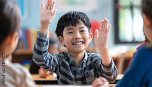 Happy Classroom Moment: Asian Boy High Fives Teacher © Oleg