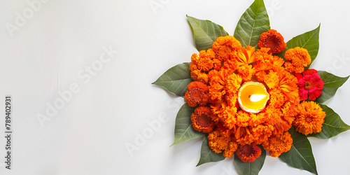 Marigold Flower Rangoli Design for Diwali Festival  Festival flower decoration Pongal made using marigold or zendo flowers and red rose petals over white background with Clay Oil Lamp in the middle. photo