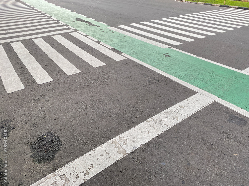 Fototapeta premium pedestrian crossing, white stripes on black asphalt, road markings zebra crossing,