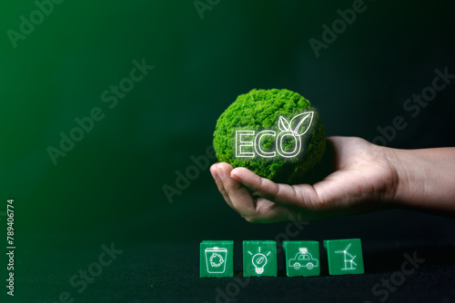 Contribute to environmental sustainability with a hand holding a green globe and eco symbol, promoting clean energy and earth preservation