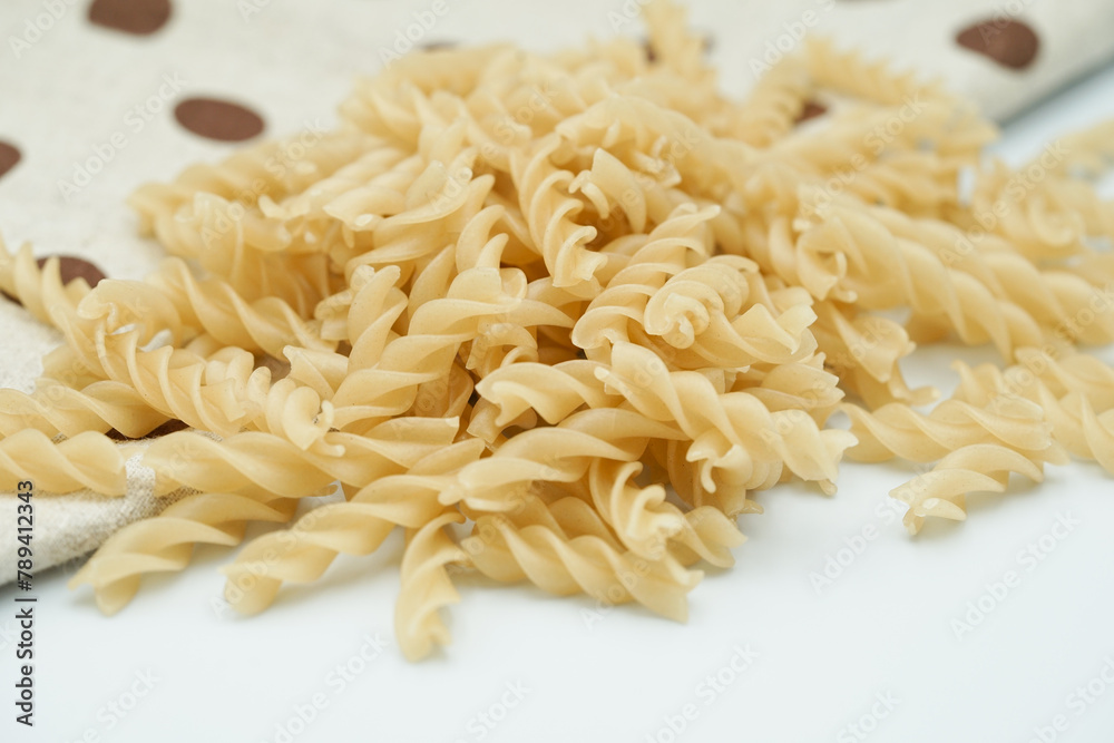 Fototapeta premium Close up of raw macaroni pasta isolated on white background.