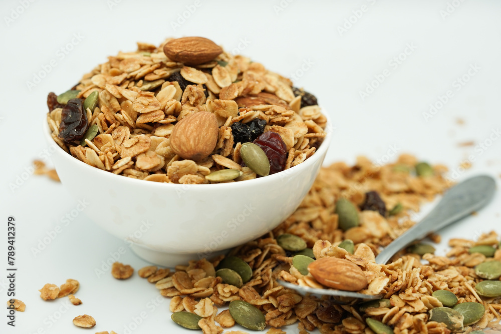 Close up of Homemade granola with mix nuts in a white bowl. Healthy snack and breakfast. Close up of Homemade granola with mix nuts in a white bowl. Healthy snack and breakfast.