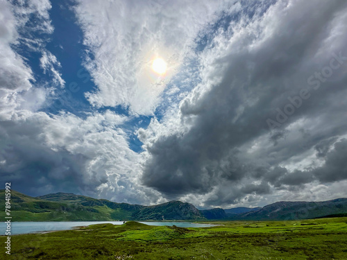 View of storm clouds with the sun shining through, over Loch Eriboll, Scotland