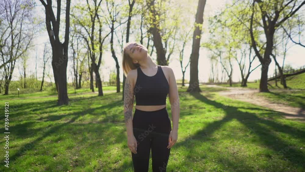 beautiful young athletic girl in leggings with a model figure on a morning jog in a green sunny park on the street. Fitness, warm-up and outdoor sports. beauty and health beautiful young athletic girl in leggings with a model figure on a morning jog in a green sunny park on the street. Fitness, warm-up and outdoor sports. beauty and health