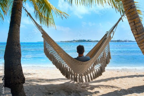 man tourist relaxing in beach hammock, vacation travel to tropical island © Song_about_summer