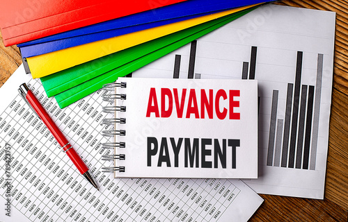ADVANCE PAYMENT text on notebook with folder on chart