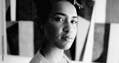 Fotografie African American young woman dramatic black and white portrait looking at camera with empowered serious expression