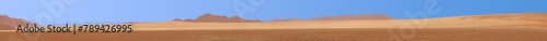 Extreme panoramic picture of the red dunes of the Namib Desert in Namibia against a blue sky in the evening light