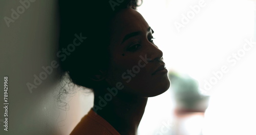 Fotografie One depressed young black latina woman leaning on wall with melancolic expressio