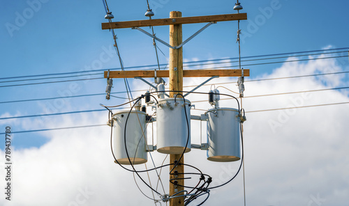 Electric pole with a three distribution transformers in Canada