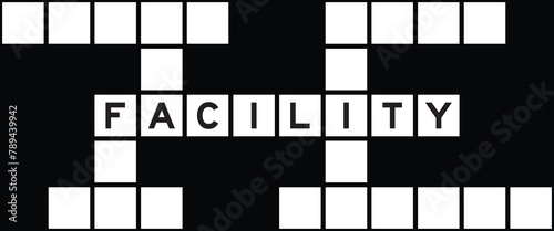 Alphabet letter in word facility on crossword puzzle background