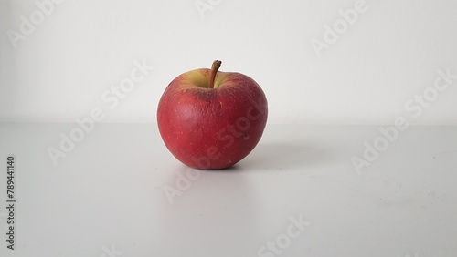red apple on a wooden table