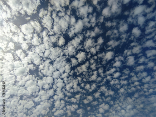many small clouds in the blue sky