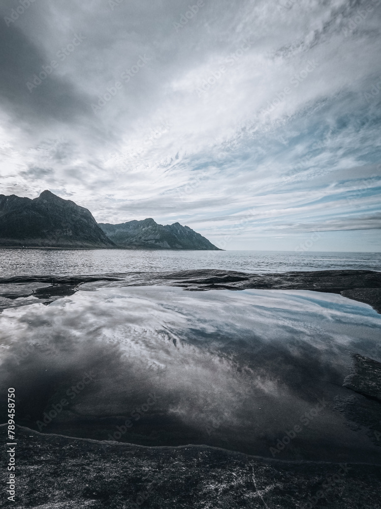Reflection on sea of clouds, rock, standing figure, in Norway Tungeneset