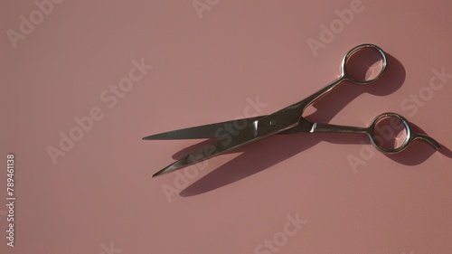 hairdressing scissors on a pink background