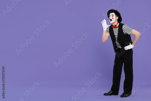 Funny mime artist in hat screaming on purple background. Space for text