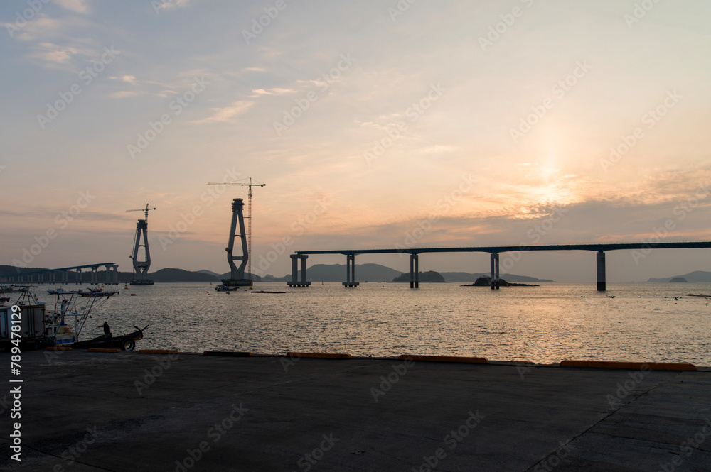Fototapeta premium constructing the bridge on the sea during sunset