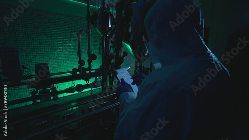 Busy scientist works in an illegal bioweapon lab, documenting experiment results  photo