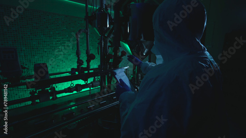 Laboratory scientist at a plant reads a plan while examining tubes, involved in criminal activity 