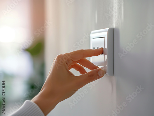 Close-up of fingers turning on home electronic switches, Concept of energy conservation and smart home technology.