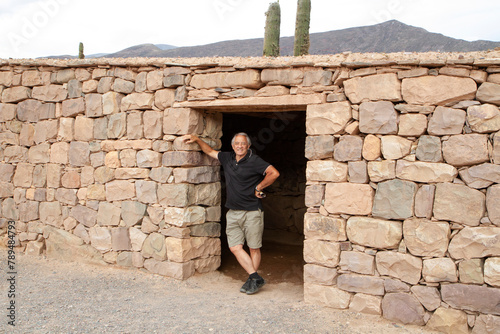 Portrait of a caucasian man in his 60s, standing in the ruins of Pucara in Tilcara, Argentina. photo