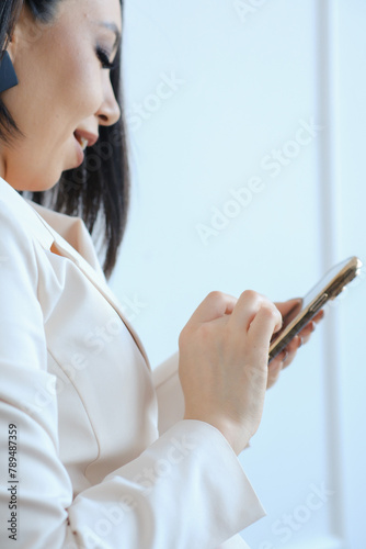  Woman is holding iphone15 pro on white background.