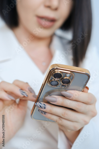  Woman is holding iphone 15 pro on white background.
