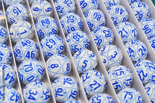 Boxed bingo balls arranged in rows close up view narrow focus field