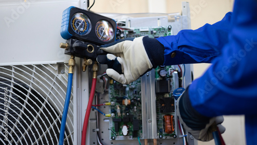 Close up Air conditioner's technician hand check  fill refrigerant liquid and maintenance condensor unit, Home care service