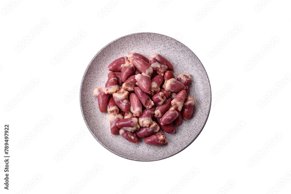 Raw chicken hearts with salt, spices and herbs Raw chicken hearts with salt, spices and herbs