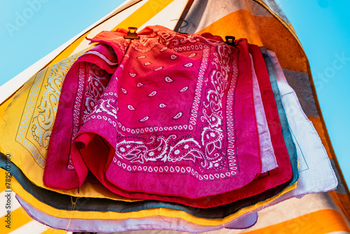 Colorful patterned scarves for sale at a market in Turin