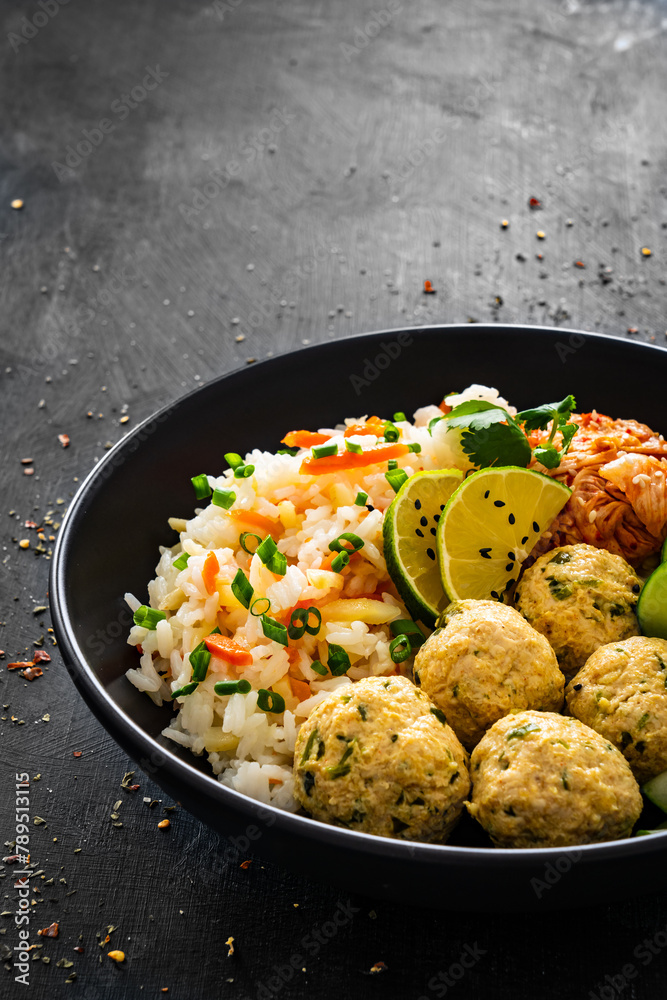 Meatballs served with white rice and marinated sliced cucumber on wooden background
Meatballs served with white rice and marinated sliced cucumber on wooden background