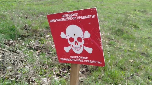 the sign Beware of Mines is installed on the minefield photo