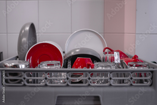 Close-up of washed cups and plates drying in the kitchen. Close-up of clean dishes. Dishwasher. High quality photo