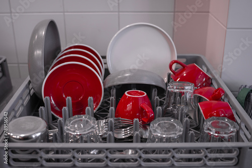 Close-up of washed cups and plates drying in the kitchen. Close-up of clean dishes. Dishwasher. High quality photo