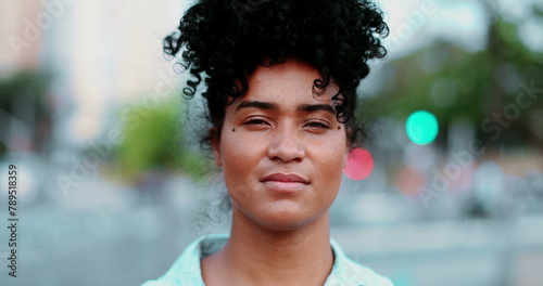 Fotografie One young black Latina woman staring at camera with serious solemn expression