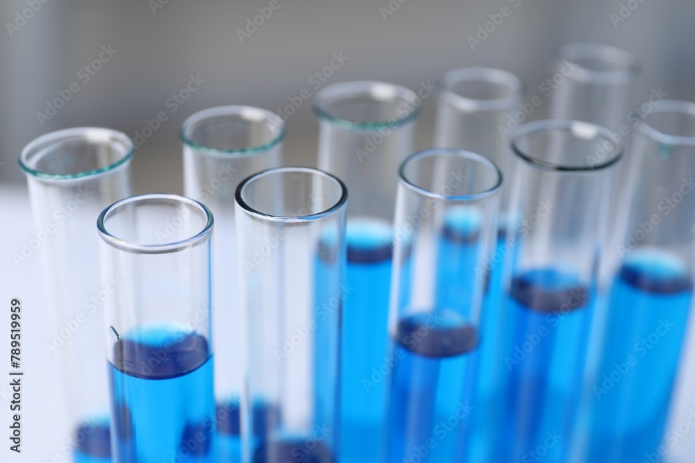 Laboratory analysis. Test tubes with blue liquid on table, closeup Laboratory analysis. Test tubes with blue liquid on table, closeup