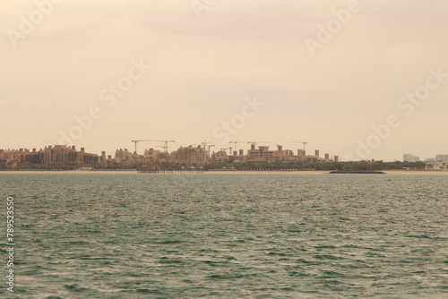 A body of water with a city in the background