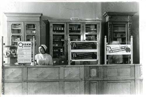 Female Pharmacist Standing at Checkout Counter  photo