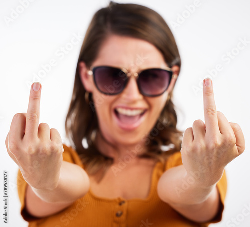 Obraz na plátne Woman, portrait and sign with middle finger for expression or flipping off on a white studio background