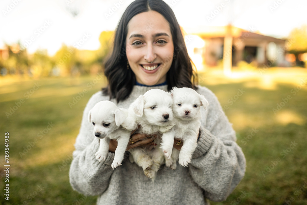 woman with dog puppies in the garden at home woman with dog puppies in the garden at home