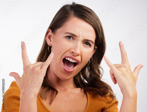 Excited, rocker hands and portrait of woman in studio with energy, confidence and fun on white background. Punk, emoji and face of model with shouting, freedom and sign music, band or concern support